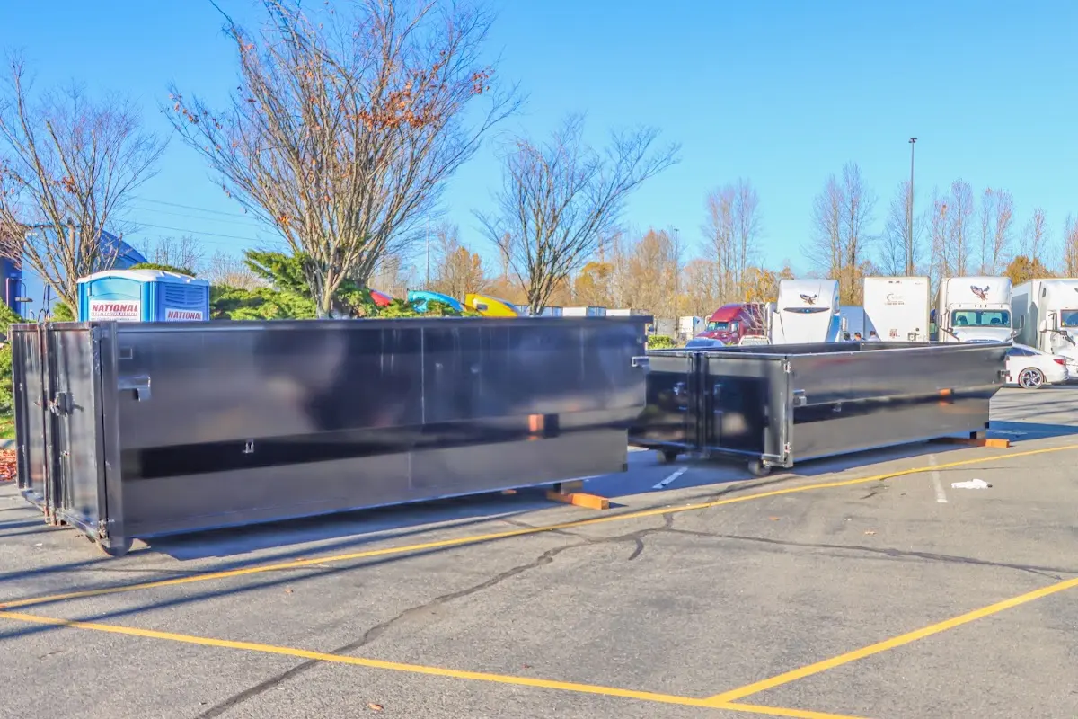 Professional dumpster rental service with roll-off container on residential driveway in Margate City